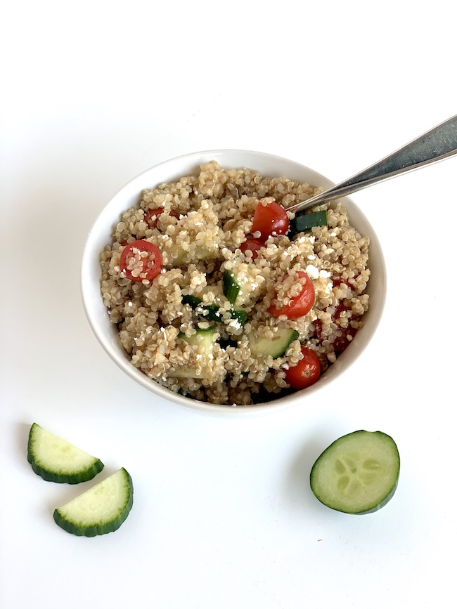 nutritious and healthy cucumber tomato quinoa salad with balsamic vinagrette and feta cheese