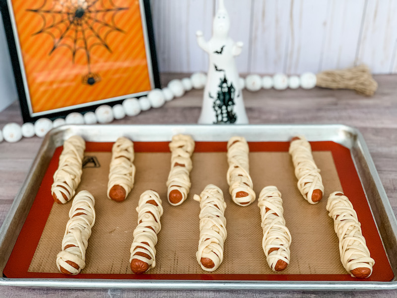 wrap hot dogs with crescent roll dough for mummy dogs