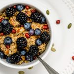 Blackberries, blueberries, and pomegranate on homemade granola